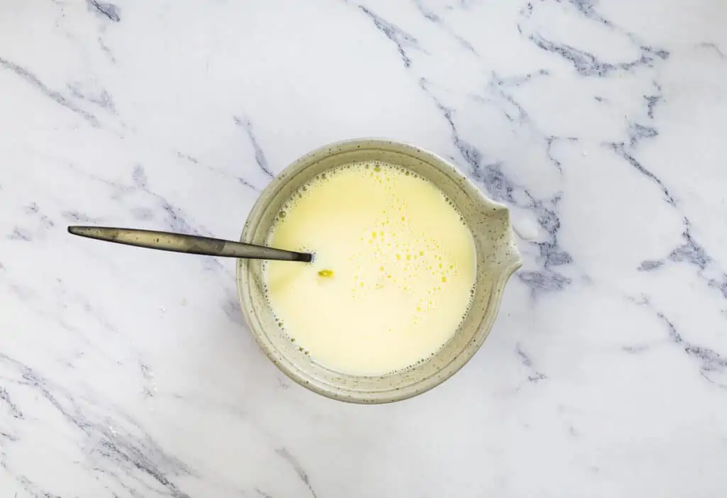 Egg and milk mixed in a smaller bowl.