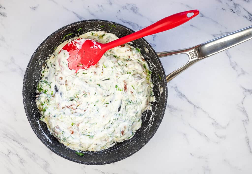 Sour cream mixed with bacon, green onions, and dill.