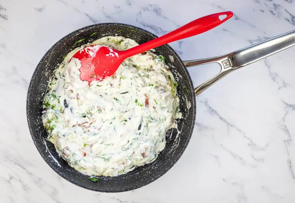 Sour cream mixed with bacon, green onions, and dill.