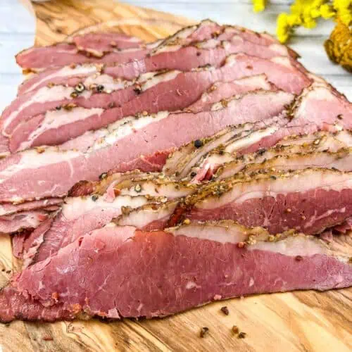 Sliced Montreal Smoked Meat on a cutting board.