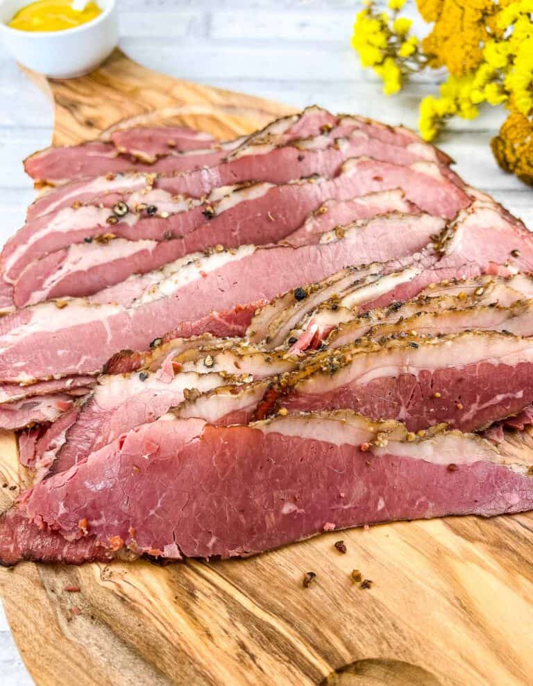 Sliced Montreal Smoked Meat on a cutting board.