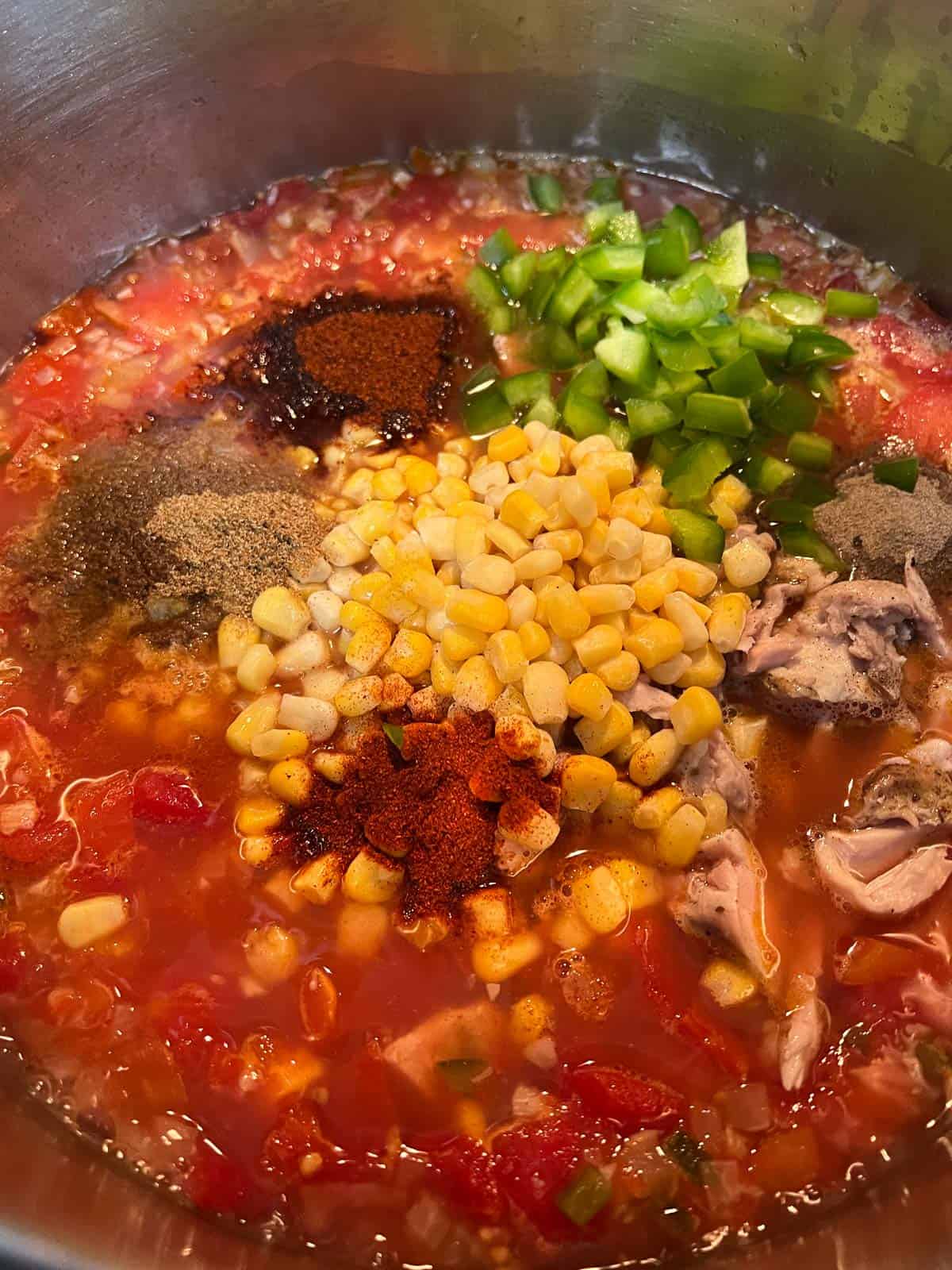 Adding remaining ingredients to the soup pot.
