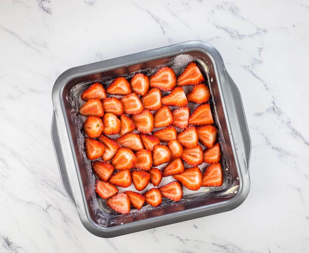 Arranged strawberries in the bottom of the baking dish.