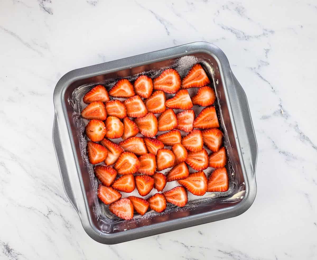 Arranged strawberries in the bottom of the baking dish.