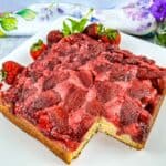 Finished Strawberry Upside Down Cake with a slice cut out of it.