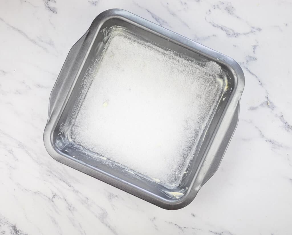 The baking dish buttered and sprinkled with sugar.