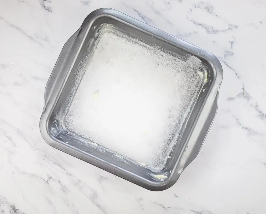 The baking dish buttered and sprinkled with sugar.