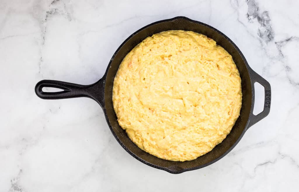 Batter in a cast iron skillet ready for the oven.