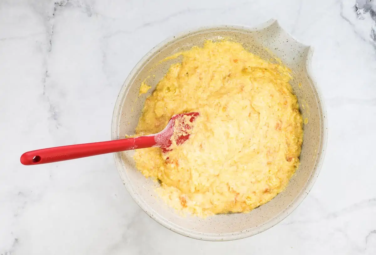 Mixed Sweet Potato Cornbread ingredients in a bowl.