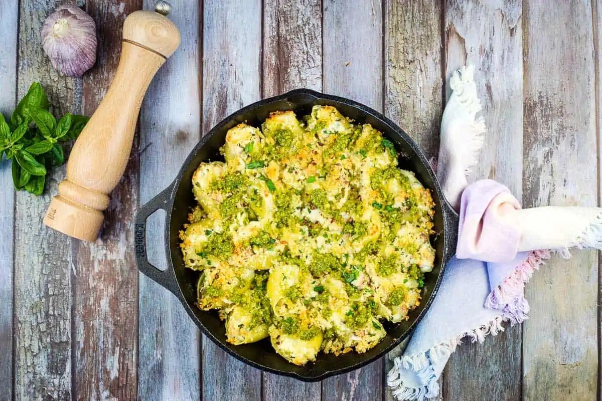 Turkey and Pesto Stuffed Pasta Shells in a black cast iron dish.