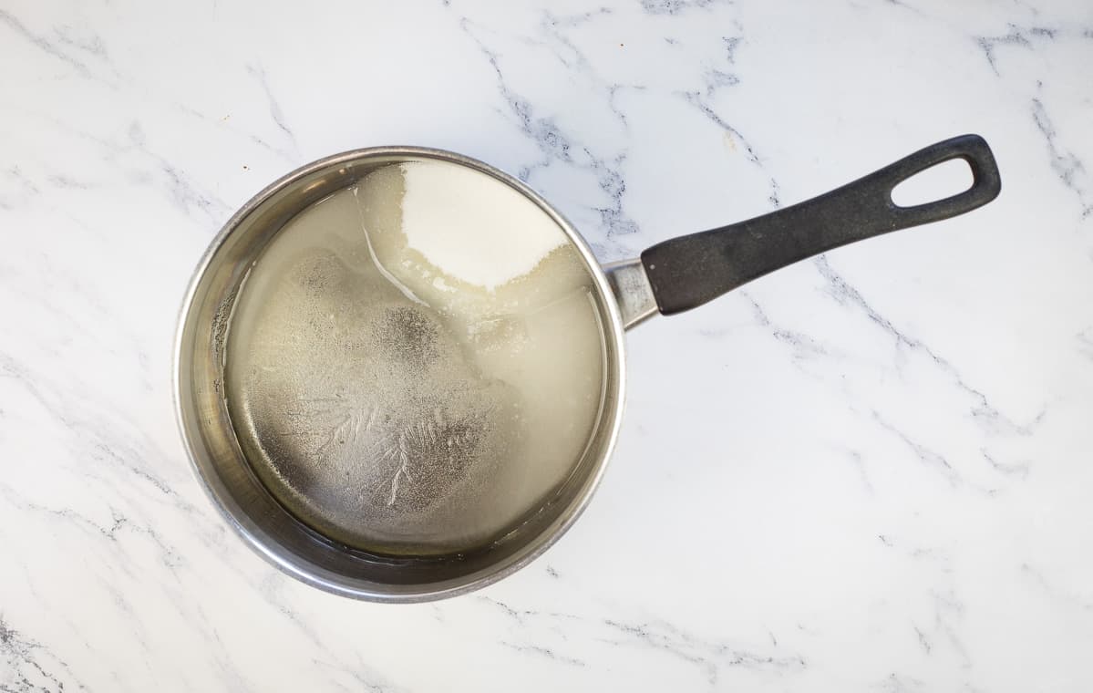 Sugar, corn syrup, and water in a pan to make the caramel.