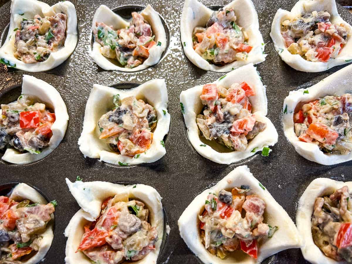 Filled tartlets ready for baking.