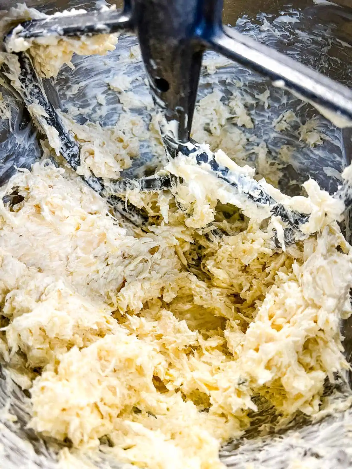 Sauerkraut mixed in with the cheese in a bowl.