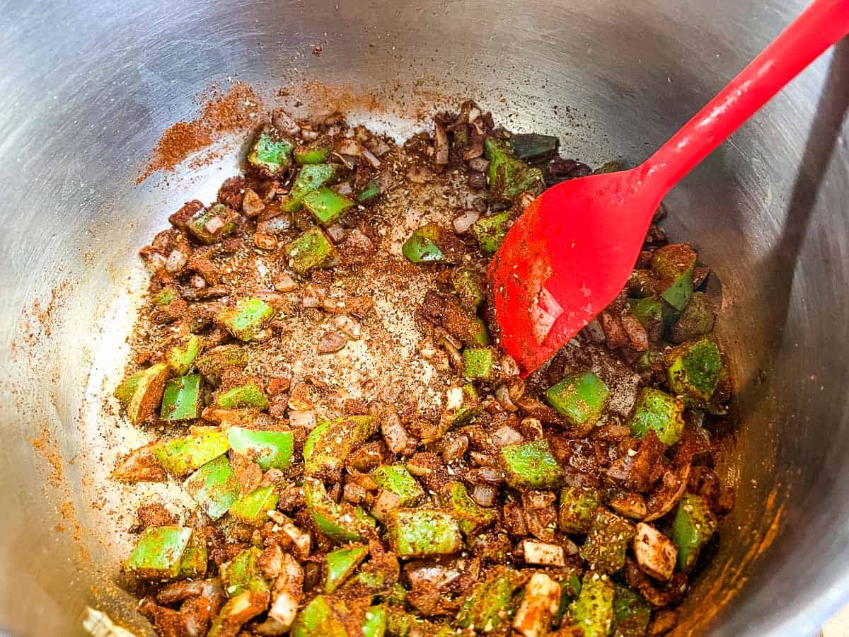 Spices added to the cooking onions and peppers.