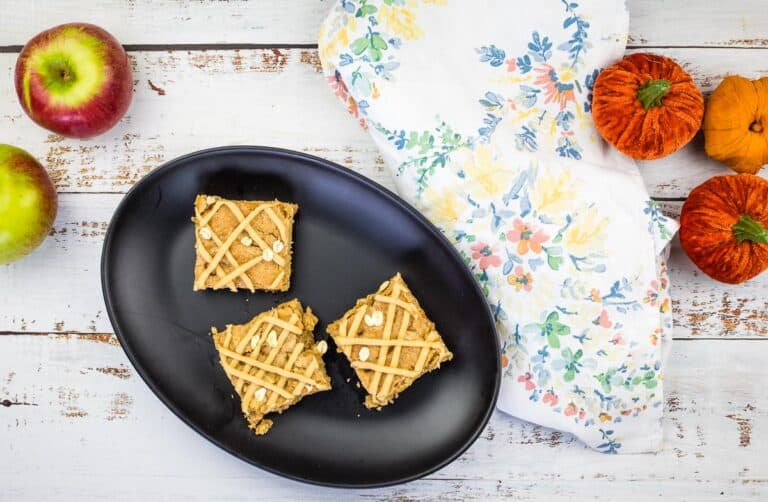 A black plate with apple blondies on it.