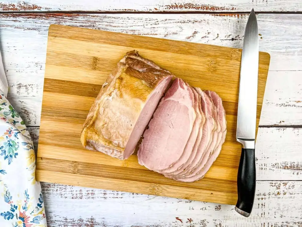 A top-down shot of sliced Back Bacon on a cutting board.