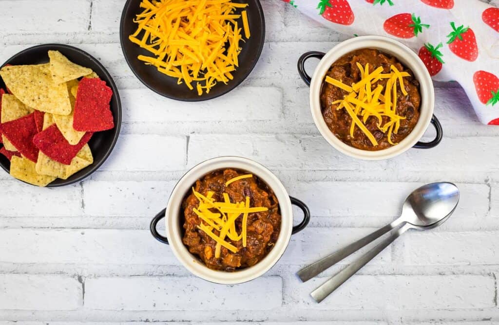 A top down shot of bowls of smoked beef chili.