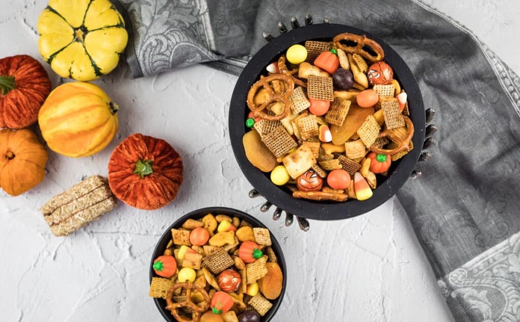 A top-down shot of spooky Spicy Chex Mix in two bowls.
