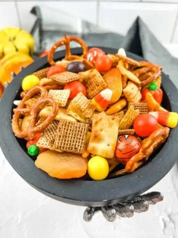 Halloween Spicy Chex Mix in a festive black bowl.