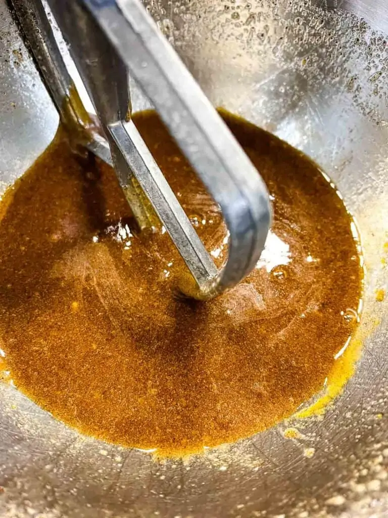 Mixing the brown butter and eggs.
