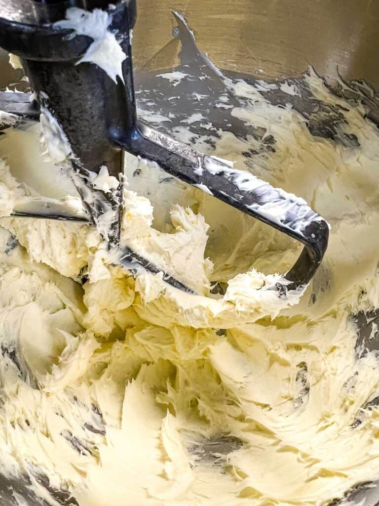 Mixing the butter and cream cheese in a stand mixer.