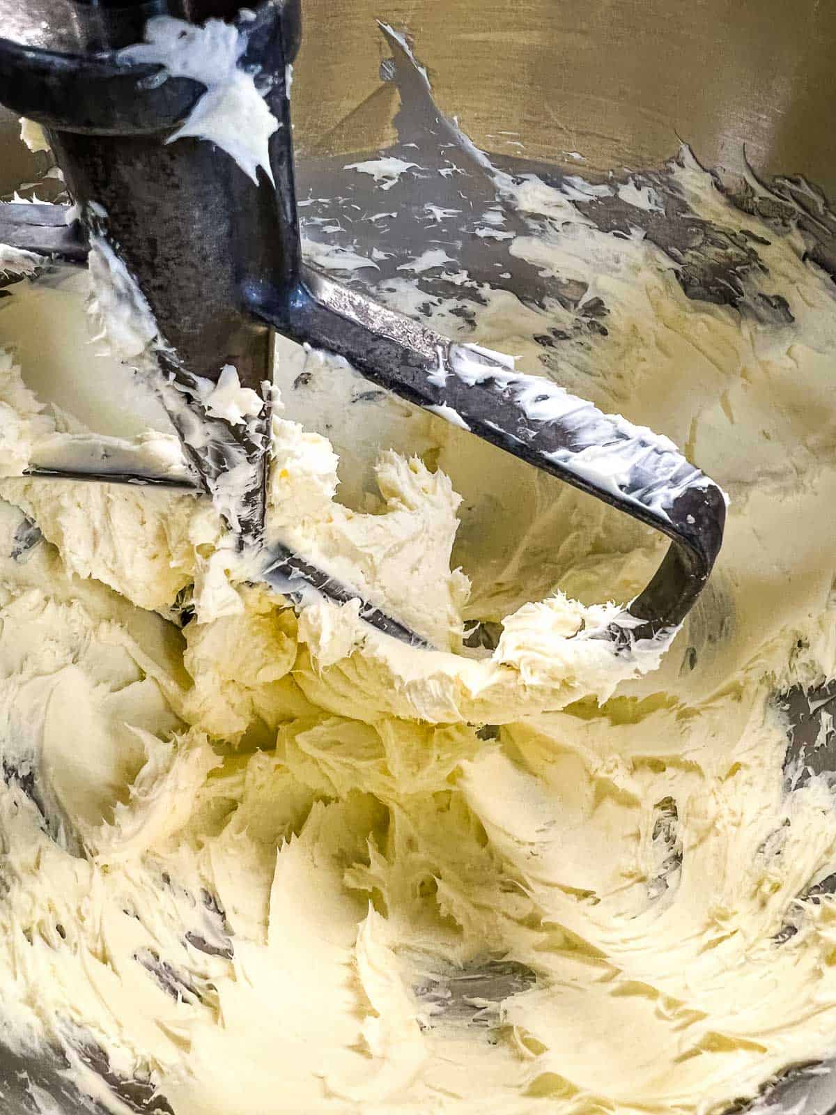 Mixing the butter and cream cheese in a stand mixer.