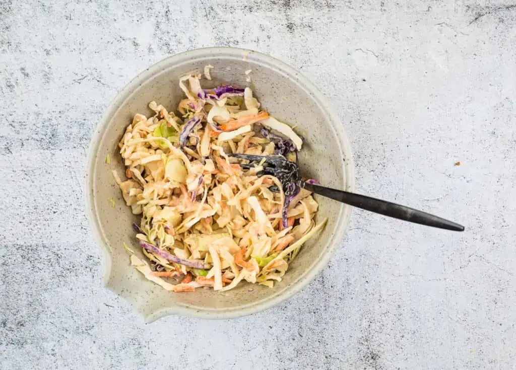 Mix the coleslaw with the dressing.