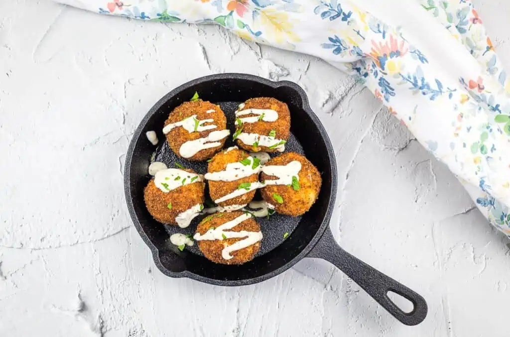 Sauerkraut balls in a black dish.