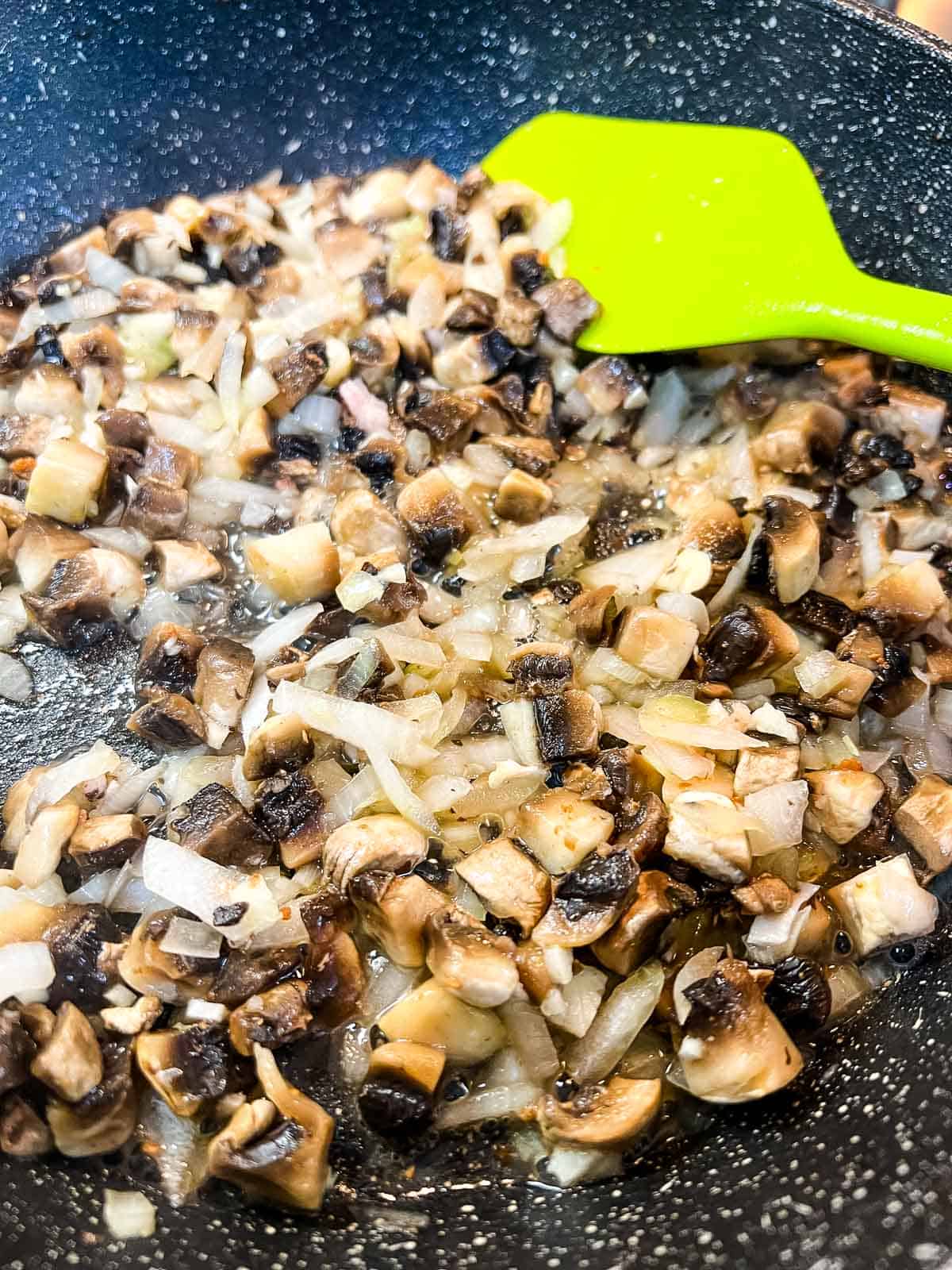 Sauteing the onions and mushrooms in the bacon fat.