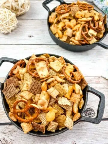 Smoked Chex Mix in 2 cast iron bowls.