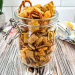 Smoked chex mix in a glass jar.