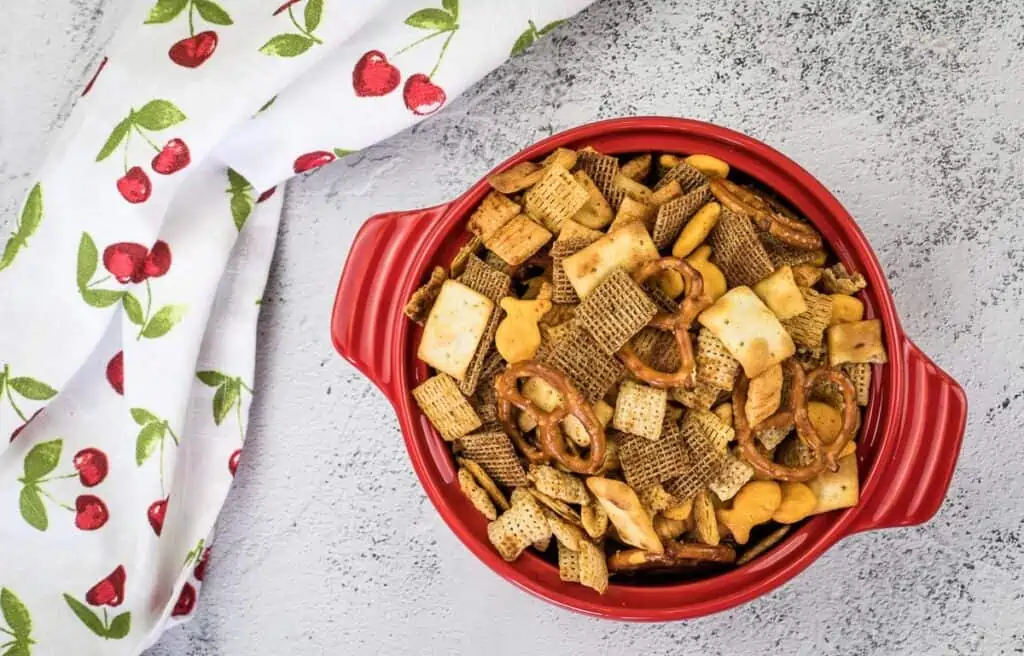 A top-down shot of Smoked Chex Mix in a red bowl.