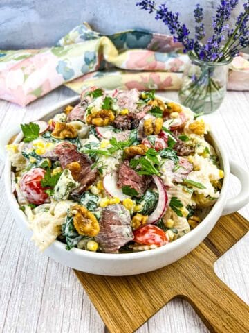 Steak and pasta salad in a white bowl