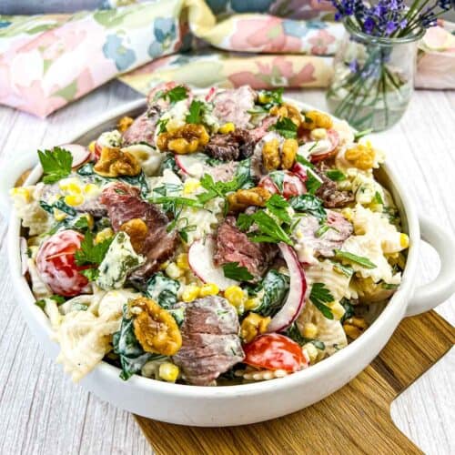 Steak and pasta salad in a white bowl