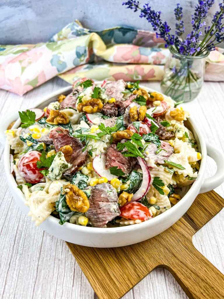 Steak and pasta salad in a white bowl