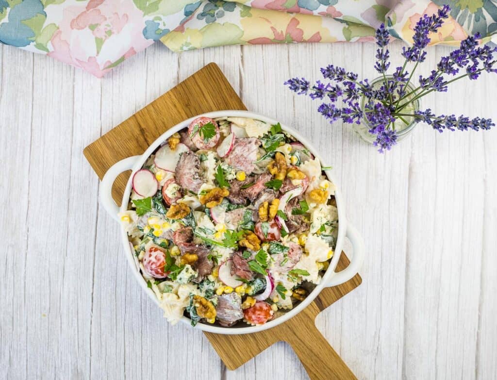 A top-down shot of Steak & Pasta Salad in a white bowl.