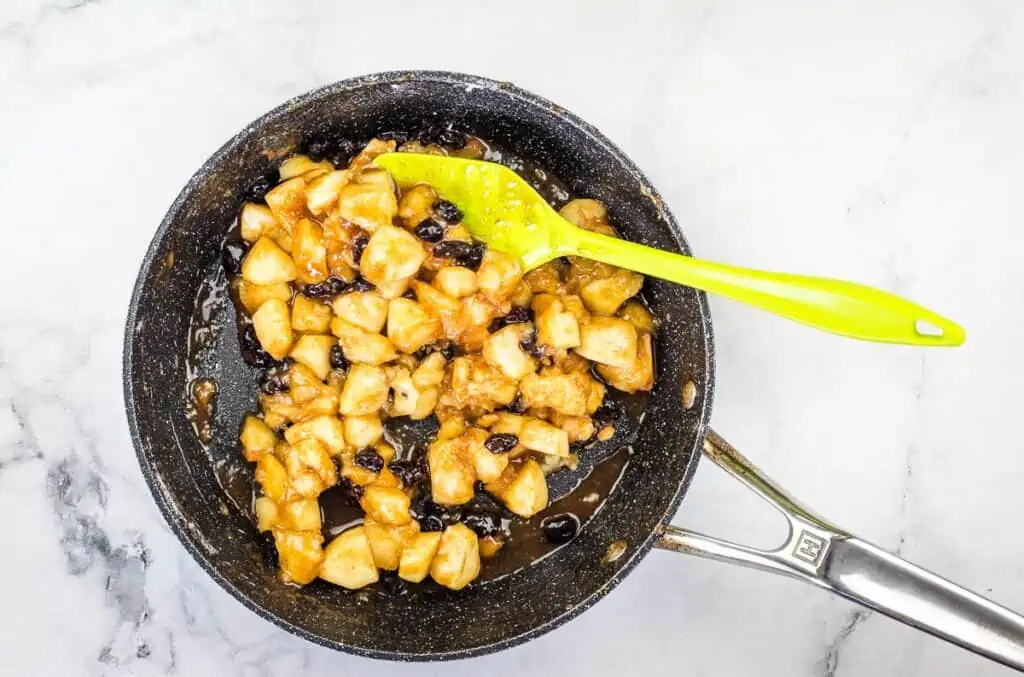 Apple filling thickened and in a skillet.