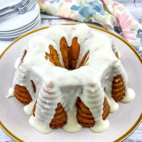 Buttermilk Banana Cake with cream cheese glaze on a plate.