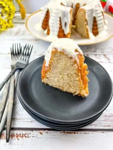 Banana Buttermilk Cake slice and the whole cake in the background.