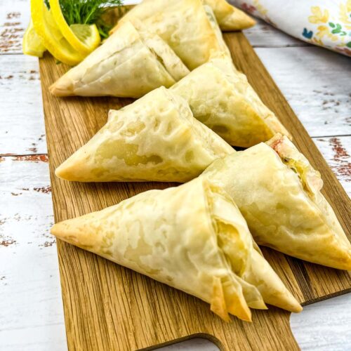 Crab Spanakopita on a wooden board.