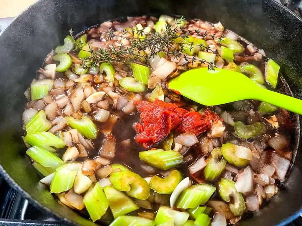 Deglazed vegetables with tomato paste added.