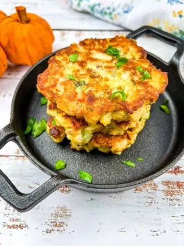 Stuffing, Turkey, and Mashed Potato Patties in a stack in a black serving dish.