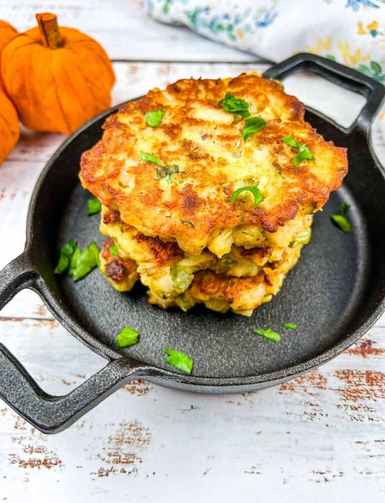 Stuffing, Turkey, and Mashed Potato Patties in a stack in a black serving dish.