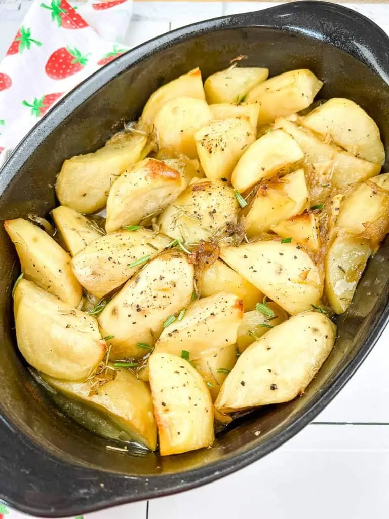 Garlic & Rosemary Braised Potatoes in a black casserole.