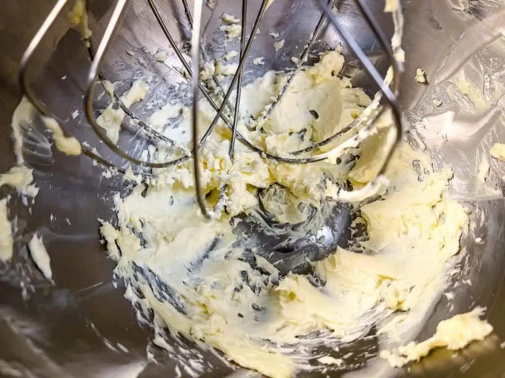 Whipping the butter and cream cheese in a stand mixer.