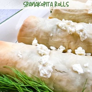 Spanakoptia rolls topped with crumbled feta.