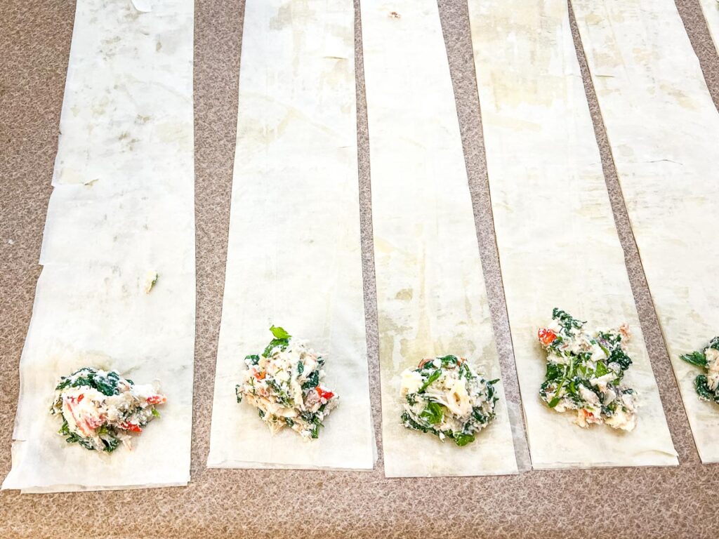Crab filling at the bottom of each phyllo strip.