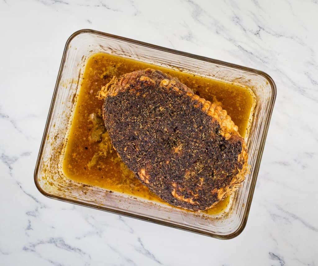 Herb-Crusted Turkey Roll roast cooked in a baking dish.