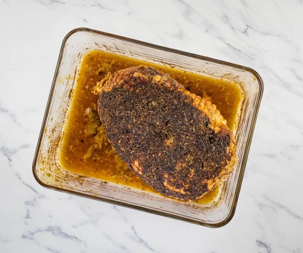 Herb-Crusted Turkey Roll roast cooked in a baking dish.