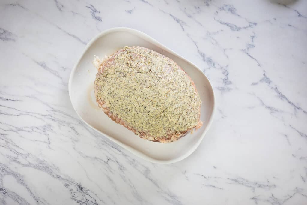 Turkey roll roast covered with herbed butter.